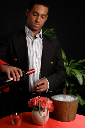 A waiter pouring wine in a fine restaurant