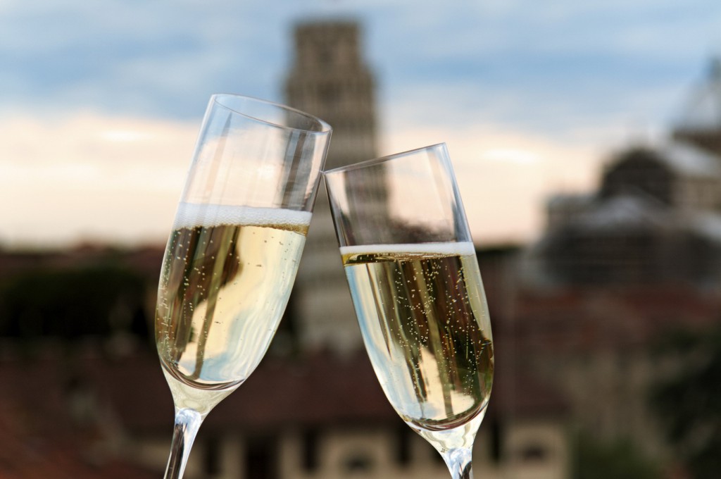 Two glasses of champagne with the Tower of Pisa in the background