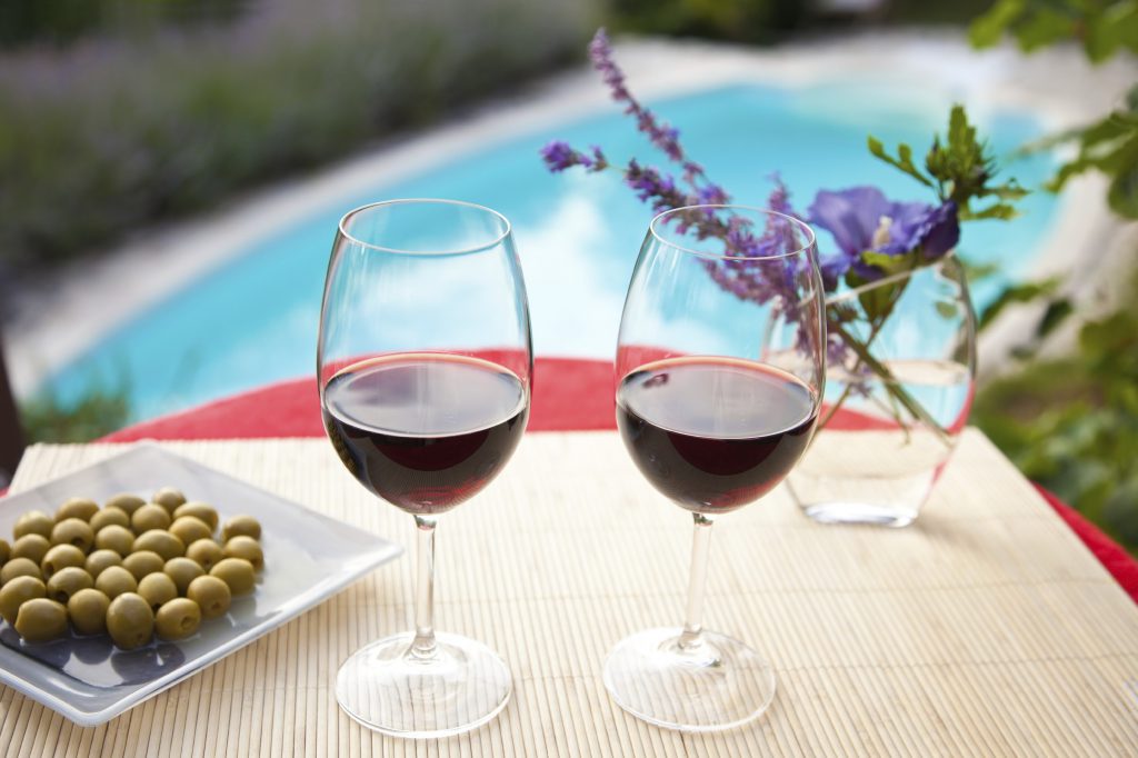 Wine glasses at the pool. Relaxing scene